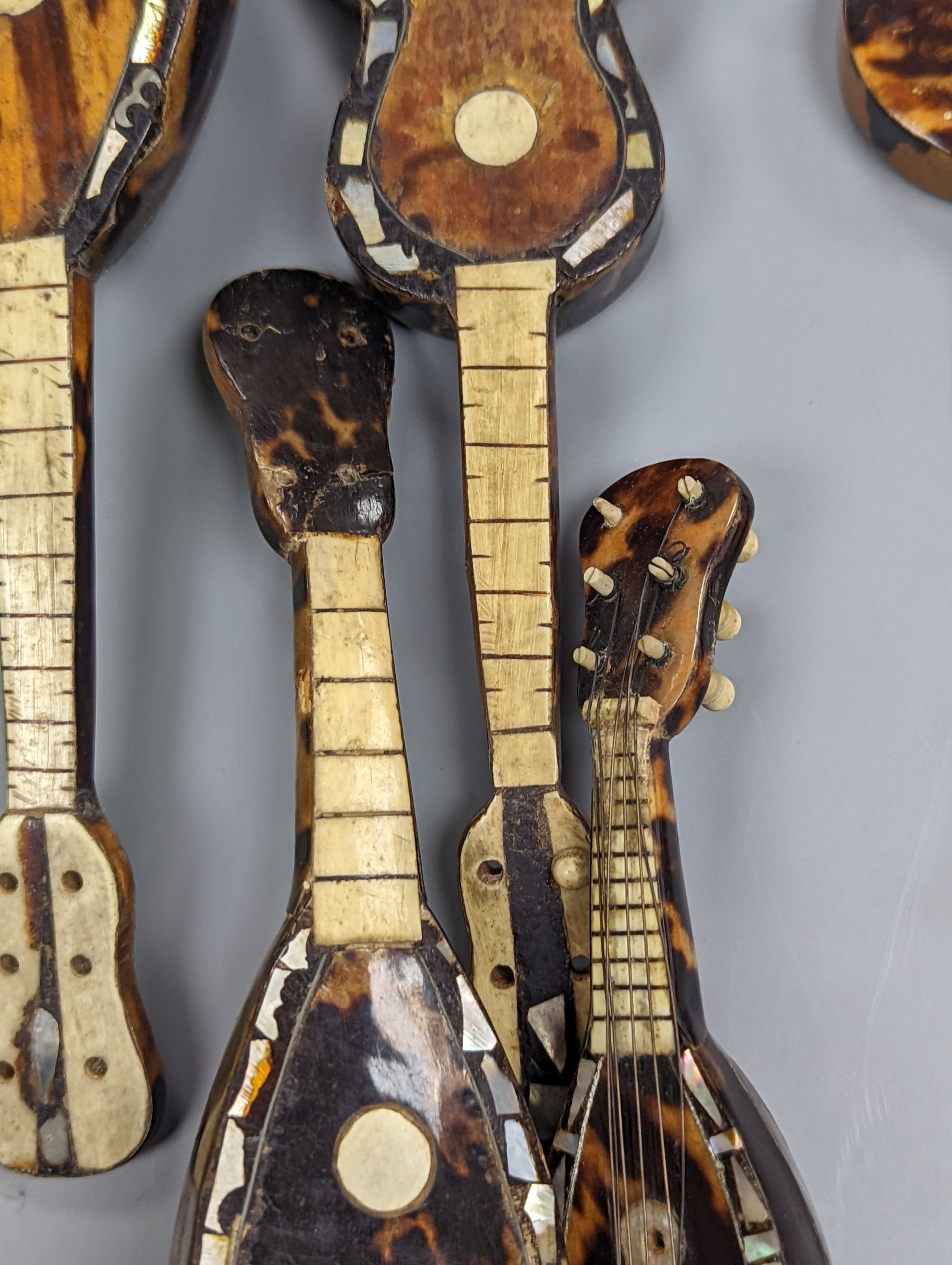 Five 19th century tortoiseshell miniature stringed instruments, longest 20cm.